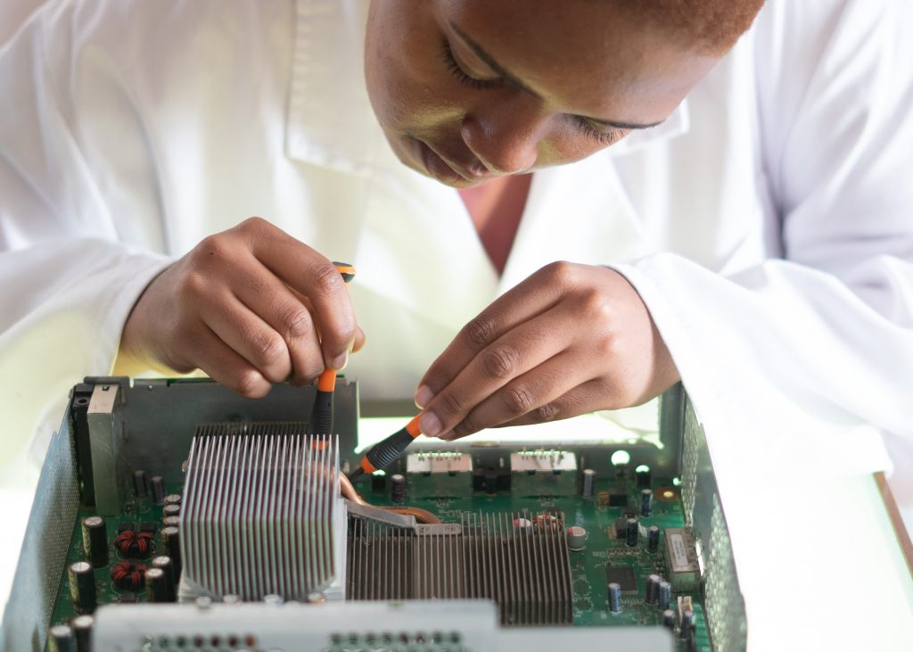 Closeup of female scientist working on circuit boards