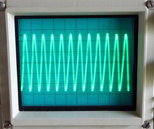 Closeup of Tektronix oscilloscope screen with waveform